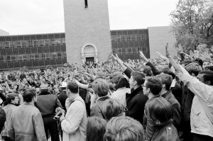 Student protestors mock police oficers by giving the sieg heil nazi salute during a demonstration near Commerce Hall and the Carillon Tower.
