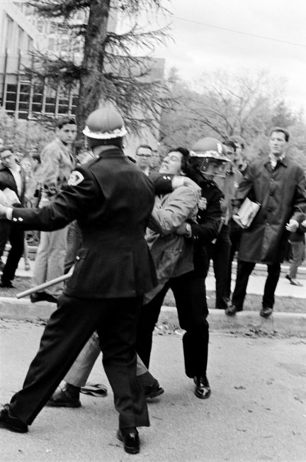 A police officer seizes a demonstrator by the neck during the Oct. 18, 1967, protest against the Dow Chemical Company on the UW-Madison campus.