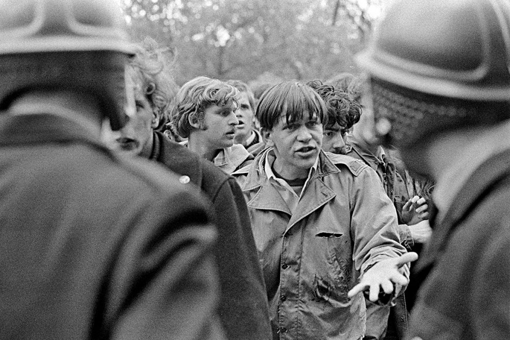 After demonstrators had been cleared from the Commerce Building, a protester faces police officers outside with an open hand, as if to say, “What’s going on?”